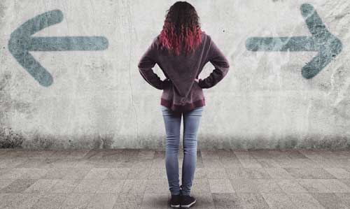 Woman looking at wall with arrows