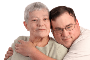 Adult son hugging aging mother