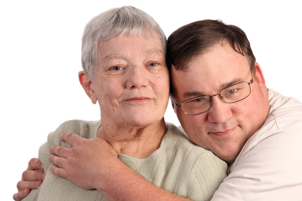 Adult son hugging aging mother