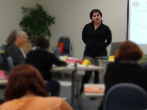 Image of instructor standing in front of adult training class