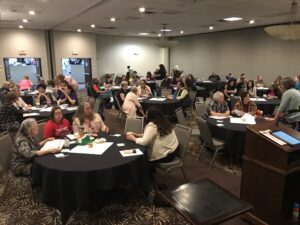 People at tables having discussions at the 2019 conference